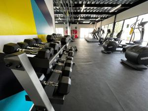 a gym with rows of treadmills and machines at Departamento LIVA estadio Akron zona real in Guadalajara