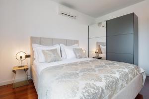 a bedroom with a large bed with white sheets and pillows at Apartman No 15 in Split