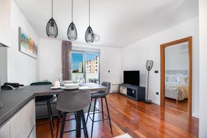 a kitchen and living room with a table and chairs at Apartman No 15 in Split
