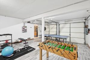 a room with a ping pong table and a gym at Spectacular 6BR 2,5BA Holiday Home with Pool in Dallas