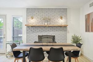 a dining room with a table and a fireplace at Spectacular 6BR 2,5BA Holiday Home with Pool in Dallas