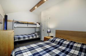a bedroom with two bunk beds and a lamp at Chalets Alpins - 17 Chemin Alpin in Stoneham