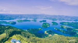 an aerial view of a large lake with islands at Lake bunyonyi view lodge in Kabale