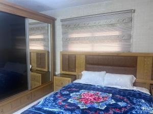 a bedroom with a bed and a large television at Ibbin hospitality house 2 in Ajloun