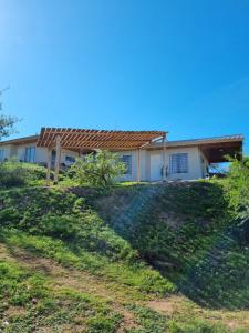 a house on top of a grassy hill at Terrazas de Estancia in Villa Carlos Paz