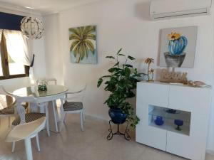 a kitchen and dining room with a table and a plant at Casa Prins 2-bed apartment with stunning views in Ciudad Quesada