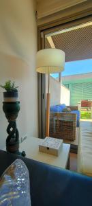 a lamp sitting on a table in a living room at Apartamento Mar&Pol con jardín in Palafrugell