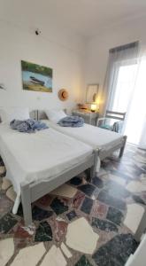 a bedroom with two beds in a room at Alkisti's seaside apartments in Pythagoreio