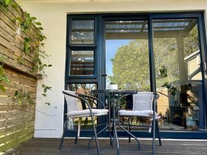 a table and chairs on a porch with a window at Nahoon Studio B in East London