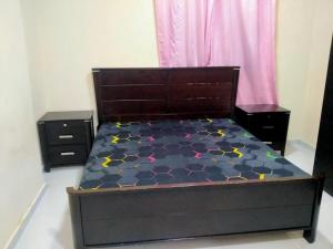 a bedroom with a bed with a black bed frame at 1 BHK Fully Furnished Flat in Sharjah