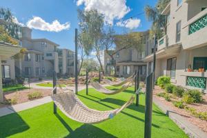a group of hammocks in a yard with buildings at Golf View Oasis-Serenity-Tranquility-Walkability N244 in Scottsdale