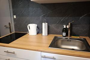 a kitchen counter top with a sink and a counter top at Le confort à 2 pas de la gare in Sens
