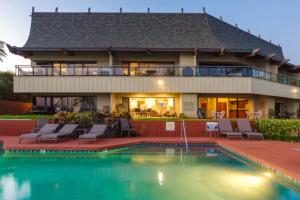 uma casa com piscina em frente a uma casa em Luxury Oceanfront ground floor condo em Kapaa
