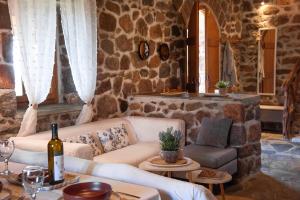 a living room with a couch and a table at peaceful place in Anítsaion