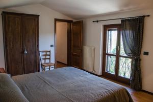 A bed or beds in a room at Le Case dell'Olmo