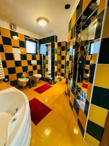 a large bathroom with a tub and a sink at Central Hostel Partener in Oradea