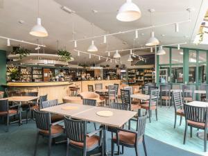a restaurant with tables and chairs and a bar at Breeze Cottage in Falmouth