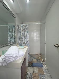 a bathroom with a shower and a sink at Mar Private Rooms in Lima