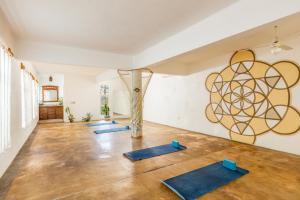 a group of yoga mats in a room with a sculpture at Hotel Villas Sayulita in Sayulita