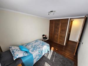 um pequeno quarto com uma cama e uma janela em Refugio IDEAL em Santiago