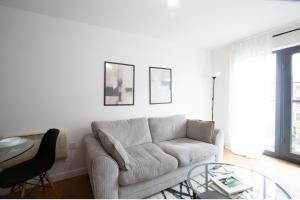 a living room with a couch and a glass table at Chic 1Bed Apt near Liverpool CC in Liverpool