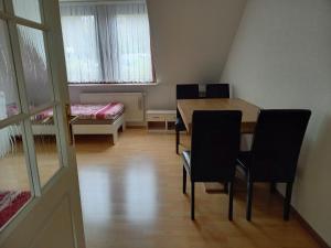 a dining room with a table and chairs and a bed at Ferienwohnung Enz, 3 OG. in Pforzheim