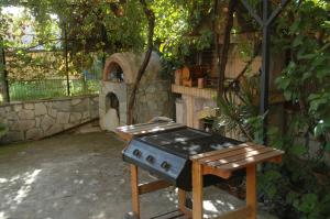 a barbecue grill in a backyard with an outdoor oven at Mare - Mare B in Patra