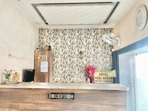 a lobby with a stone wall with a counter at HOTEL NEEL GAGAN ! VARANASI fully-Air-Conditioned hotel at prime location, near Kashi Vishwanath Temple, and Ganga ghat in Varanasi