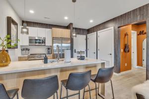 a kitchen with a counter and chairs in a room at The Stage in Downtown Nashville by Nautical Properties in Nashville