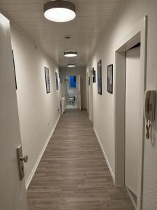 a hallway in a hospital with a long corridor at 5-Bett Wohnung im Boardinghaus Elisabeth in Dinslaken