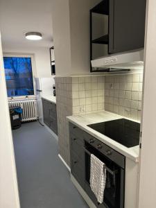 a kitchen with a sink and a stove at 5-Bett Wohnung im Boardinghaus Elisabeth in Dinslaken