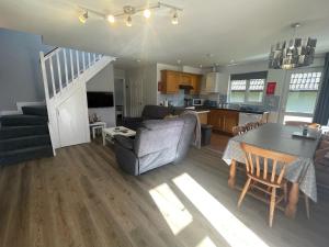 a living room and kitchen with a couch and a table at Hengar Manor 4 bed Sleeps 9 in Saint Tudy