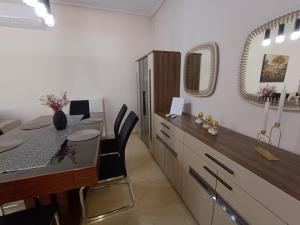 a dining room with a table and a mirror at NEW elegant roof apartment in Acharnes