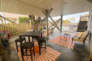 a patio with a table and chairs and a playground at Double Blessing in North Topsail Beach