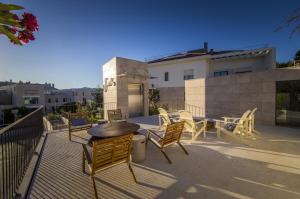 a patio with chairs and a table on a roof at Somewhere - Estoril Guesthouse in Estoril