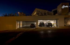 two cars parked in a garage at night at Somewhere - Estoril Guesthouse in Estoril