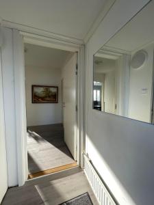 un pasillo con un espejo grande en una casa en Serenity Cottage 2, en Närpiö