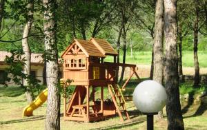a tree house with a slide and a playground at Valle Dei Pini in Lenola