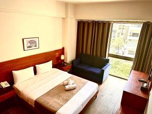 Voodi või voodid majutusasutuse Caesar's Park Hotel toas