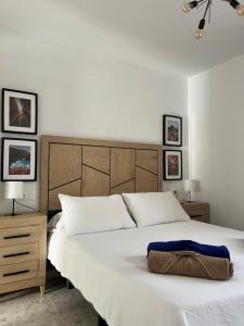 a bedroom with a large bed with a brown bag on it at Garana in Playa Blanca