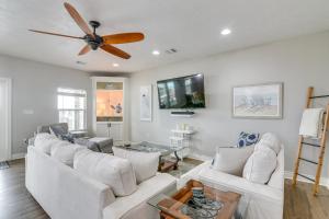 a living room with white furniture and a ceiling fan at Modern Crystal Beach Escape, Walk to Beach! in Crystal Beach