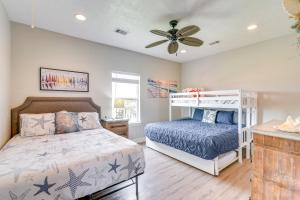 a bedroom with a bed and a ceiling fan at Modern Crystal Beach Escape, Walk to Beach! in Crystal Beach
