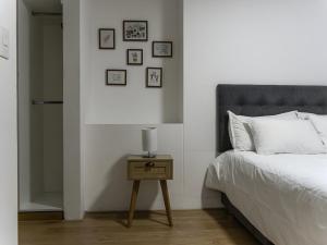 a bedroom with a bed and a table with a lamp at 2BR in Center of Miraflores La Paz in Lima