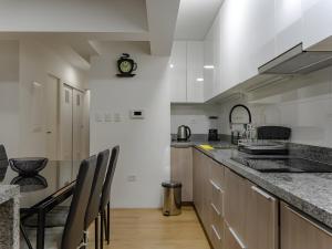 a kitchen with a counter and chairs in it at 2BR in Center of Miraflores La Paz in Lima