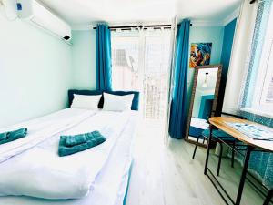 a bedroom with a large bed with blue walls at VELI HOUSE VELINGRAD/ ВелиХаус Къща за гости Велинград in Velingrad