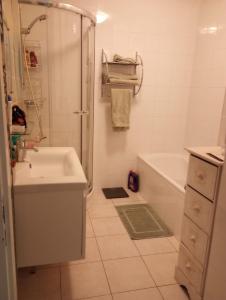 ein Bad mit einer Badewanne, einem Waschbecken und einer Dusche in der Unterkunft Le Saint Roch in Menton