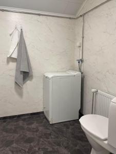bagno con piccolo frigorifero e servizi igienici di Serenity Cottage a Närpiö