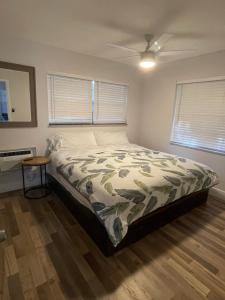 a bedroom with a bed and a ceiling fan at City First Story Apartments & Cottage in Fort Lauderdale