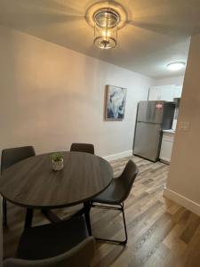 a dining room table with chairs and a refrigerator at City First Story Apartments & Cottage in Fort Lauderdale
