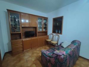 a living room with a couch and a tv at Casa Innocenti Daniele in Volterra